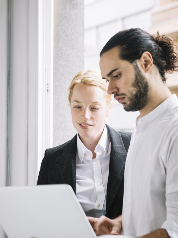 young-businessman-businesswoman-using-laptop